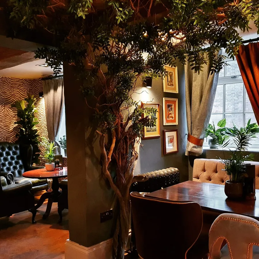 Booth seating around the tree in the bar